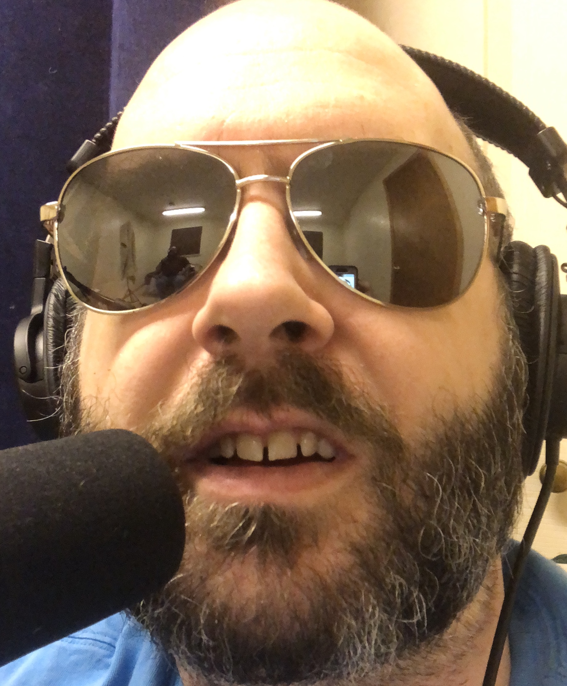 Image of Jon wearing aviator style sunglasses. Image is evocative of Wolfman Jack